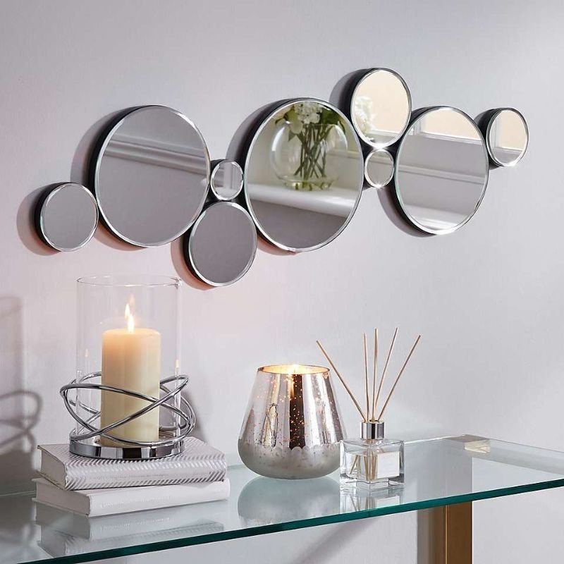 "Different mirror styles for dining room wall decor including round and arched designs"