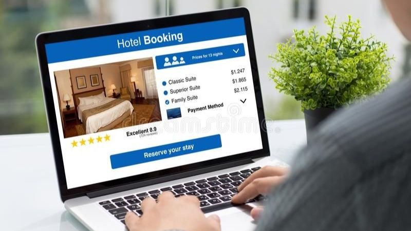Person searching rooms for rent online using rental websites on a laptop for affordable housing options