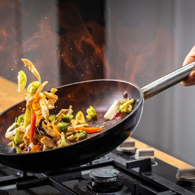Chinese stir fry cooking with wok hei technique