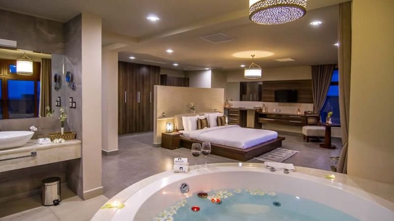 Couple enjoying a romantic Jacuzzi hotel suite
