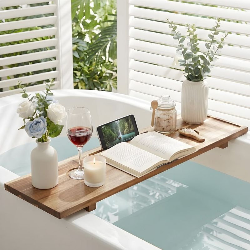 wooden bathtub tray holding candle and book