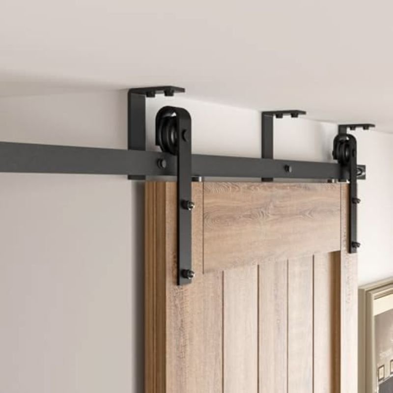Installing a barn door using wall mounted track system