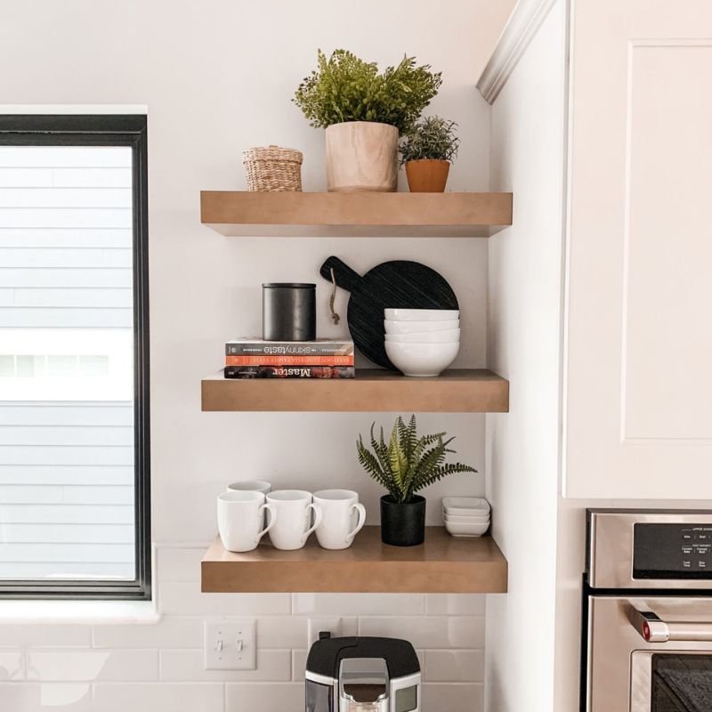 Open kitchen wall shelves displaying dishes and glassware