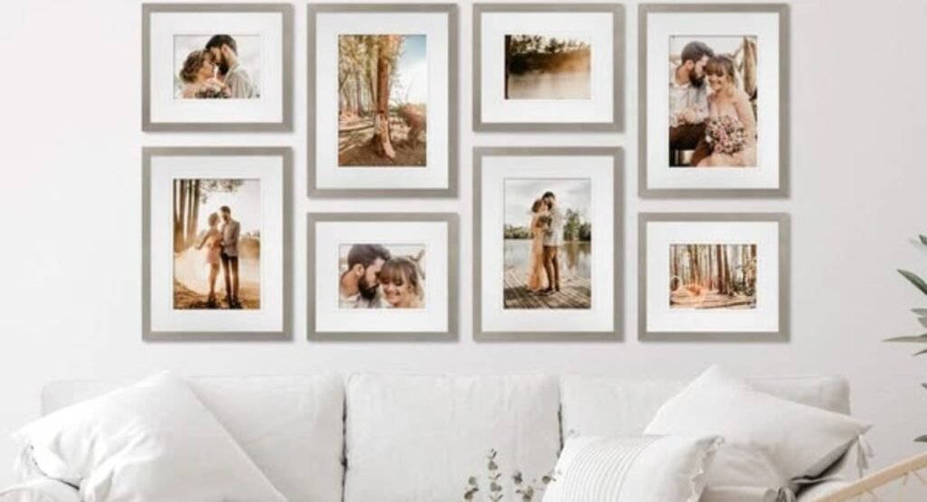 Person arranging picture frames on the floor